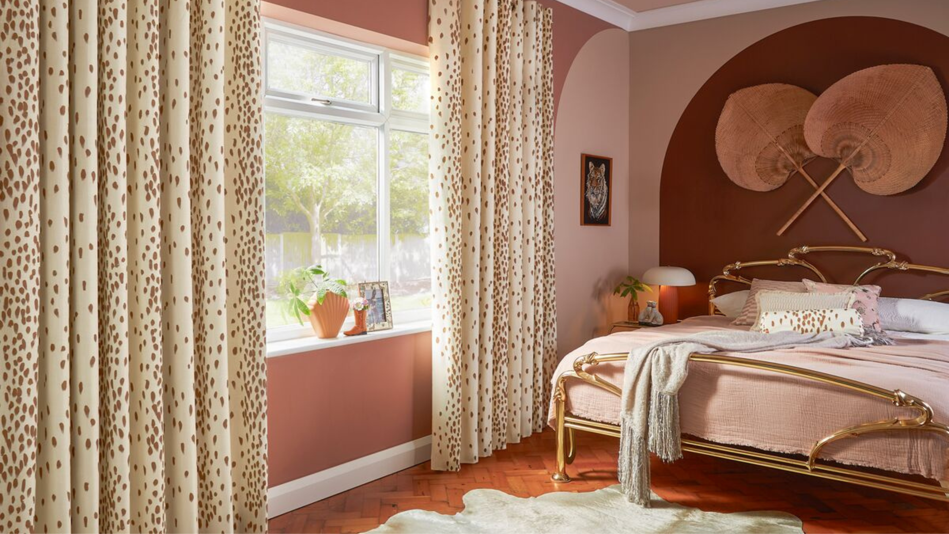 Bedroom in orange, red and brown with Hillarys curtains