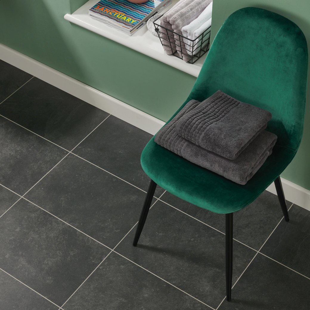 Knight Tile Black Riven Slate black LVT flooring with a chair