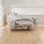 Van Gogh Canadian Nude Oak mid brown LVT flooring laid in a bedroom