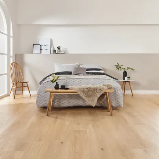 Van Gogh Canadian Nude Oak mid brown LVT flooring laid in a bedroom